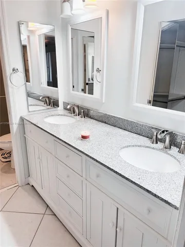 a bathroom with a double vanity sink and a mirror