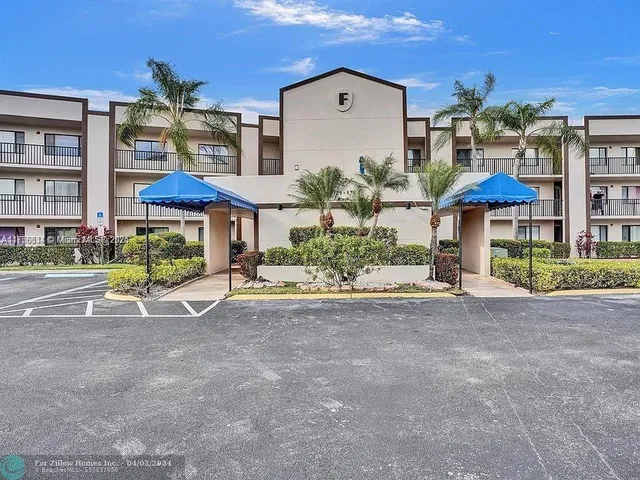 a view of patio with a table and chairs under an umbrella