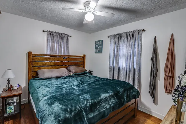 a bed sitting in a bedroom next to a window