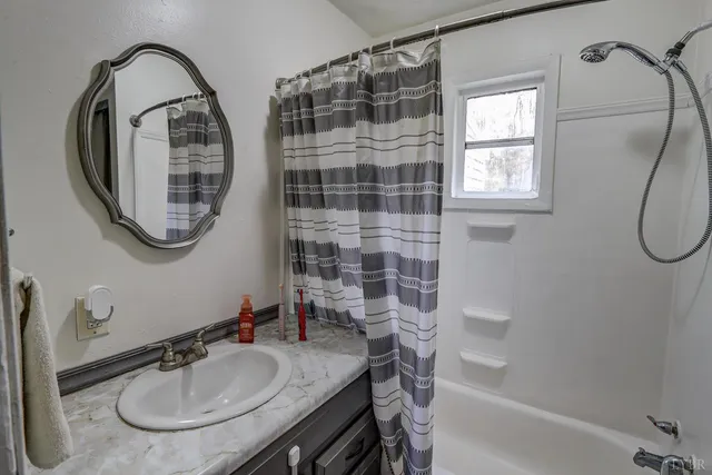 a bathroom with a sink a mirror and a bathtub