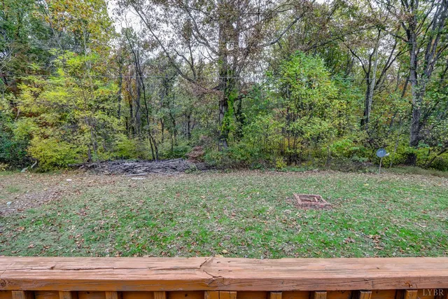 a view of a wooden fence and trees