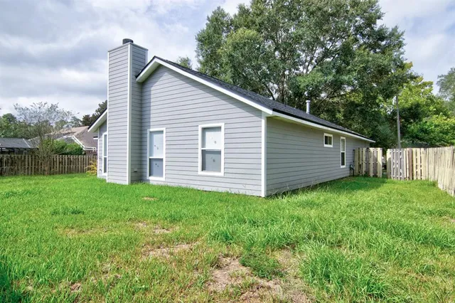 a view of a backyard with plants and a garden