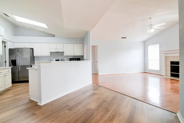 a view of kitchen with cabinets and wooden floor