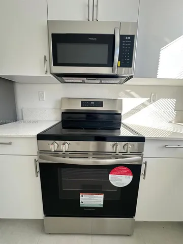 a kitchen with stainless steel appliances a sink a stove and a microwave