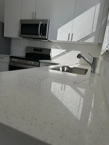 a view of empty room with furniture and window