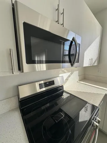 a kitchen with stainless steel appliances a refrigerator a stove a microwave and cabinets