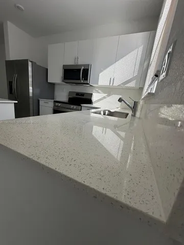 an empty room with a empty space and windows