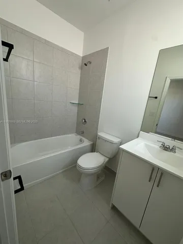 a bathroom with a double vanity sink toilet and shower
