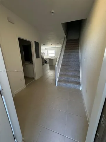a kitchen with a refrigerator and a stove