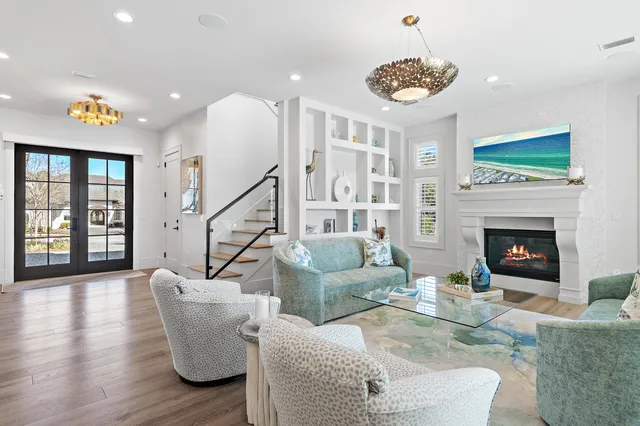 a living room with furniture a table and a fireplace