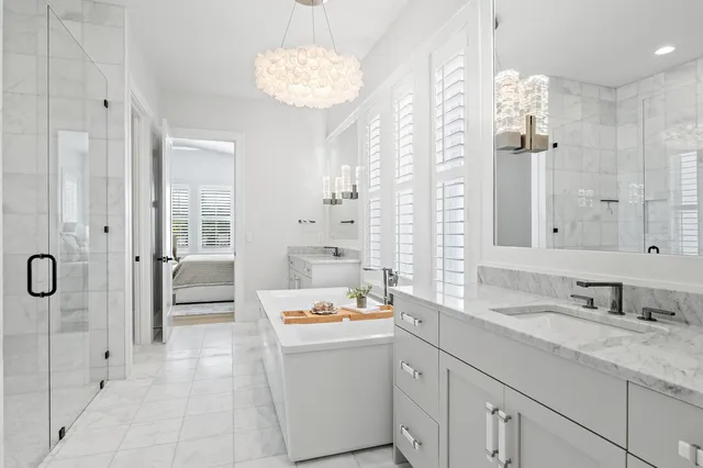 a bathroom with a double vanity sink mirror and shower