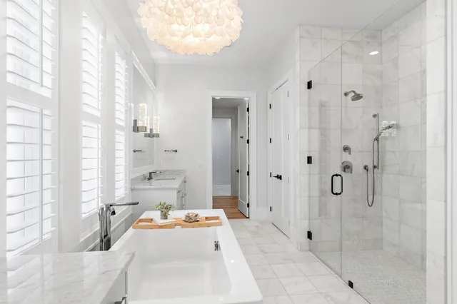 a bathroom with a tub shower and sink