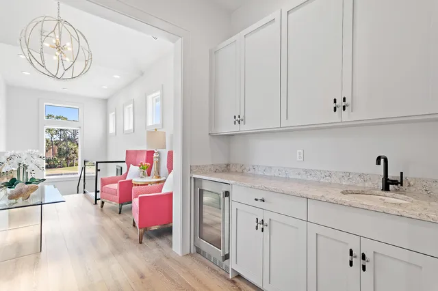 a kitchen with a sink cabinets and wooden floor
