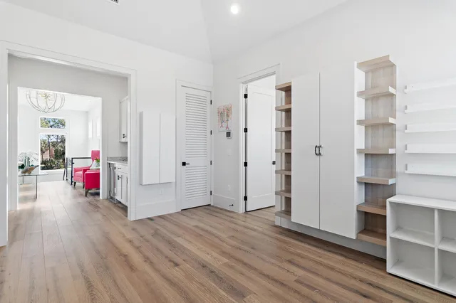 a view of a livingroom with wooden floor and furniture