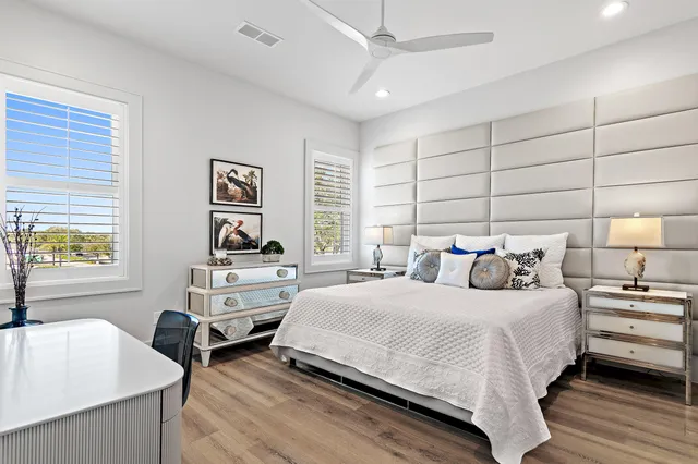 a bedroom with a bed and a large window