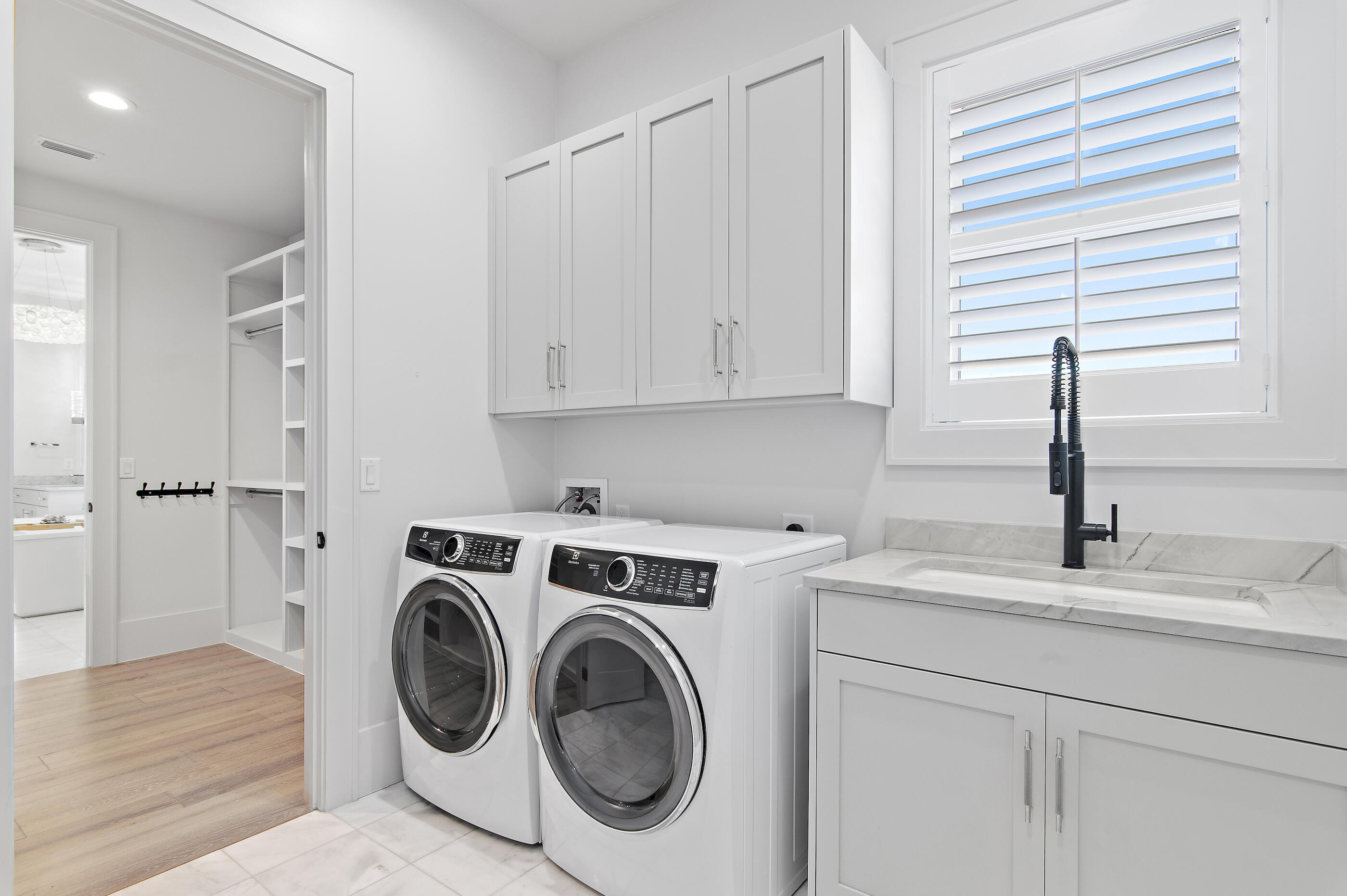 4572 Sailmaker Lane Destin, FL 32541 - Photo 43 of 49 a utility room with sink dryer and washer