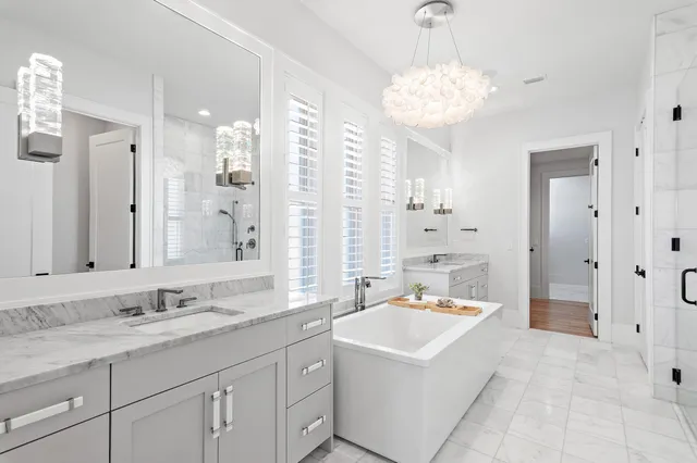 a spacious bathroom with a sink double vanity and a mirror