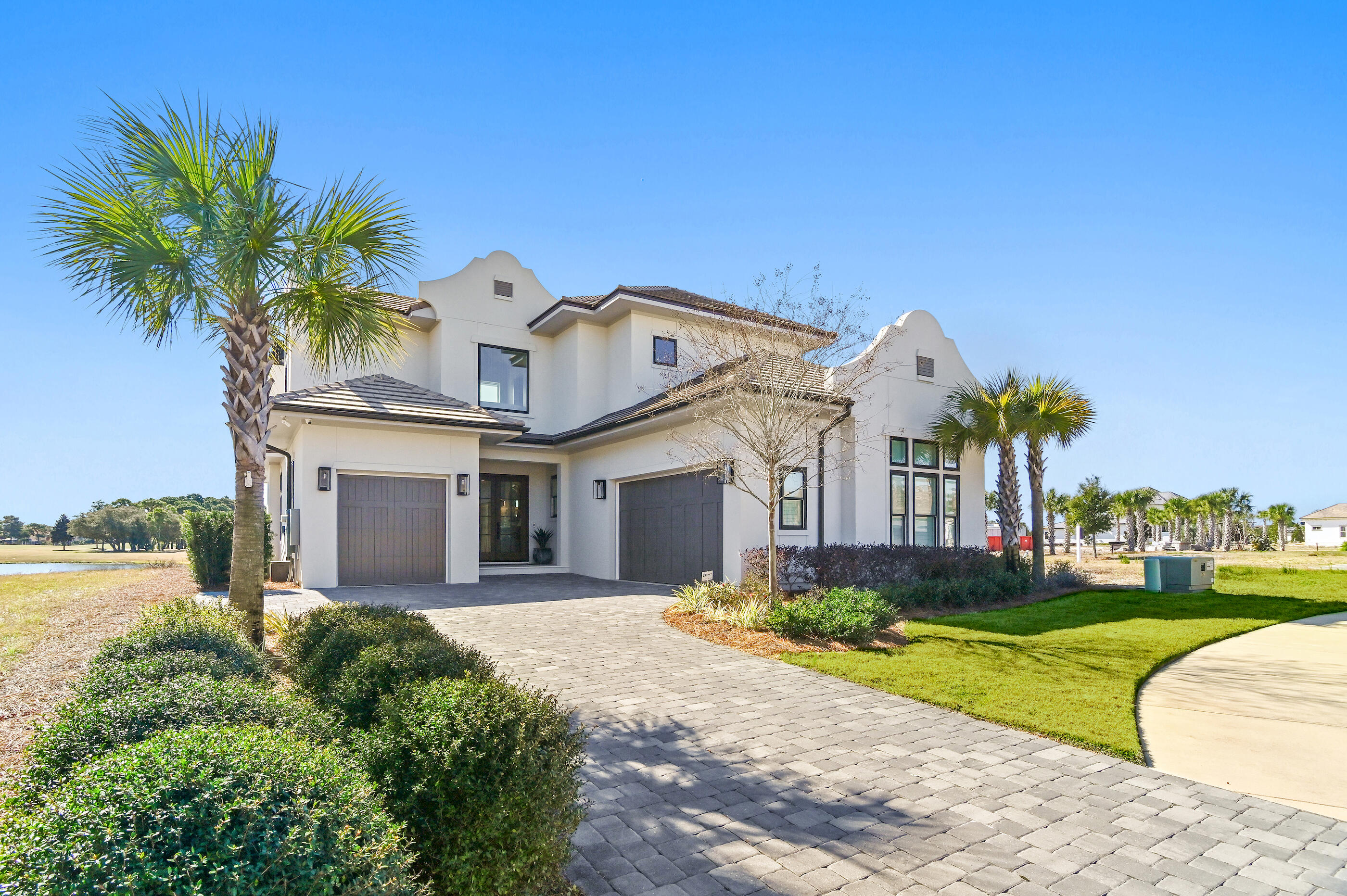 4572 Sailmaker Lane Destin, FL 32541 - Photo 9 of 49 a front view of a house with a yard and potted plants