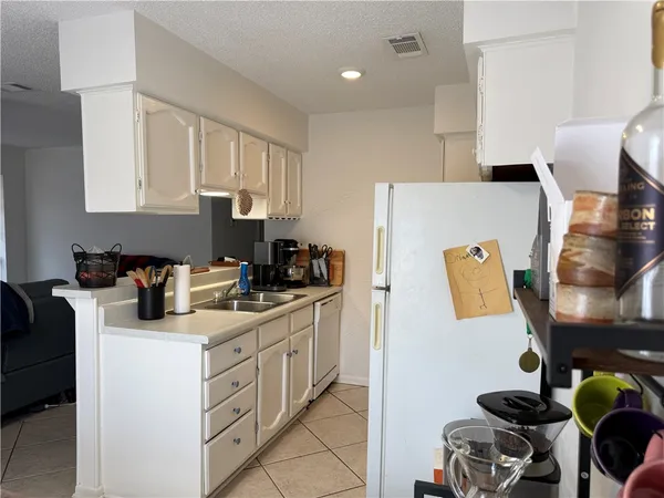 a kitchen with stainless steel appliances granite countertop a sink stove and white cabinets