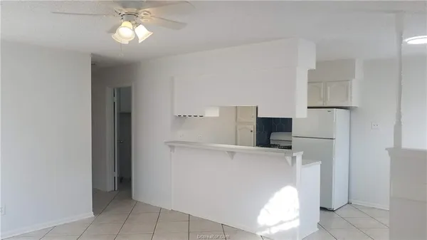 a view of a kitchen with refrigerator and microwave