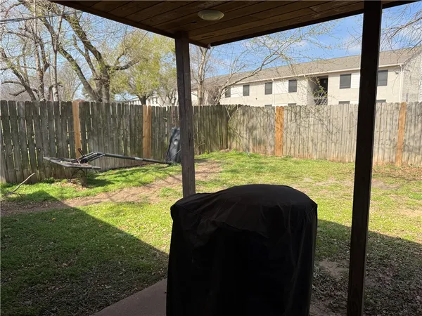 a view of a back yard with a small yard and furniture