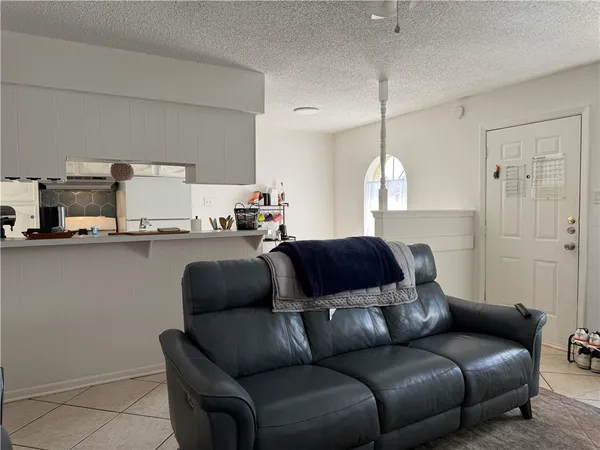 a living room with a couch and a chandelier