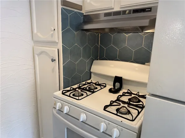 a kitchen with a stove and a cabinet