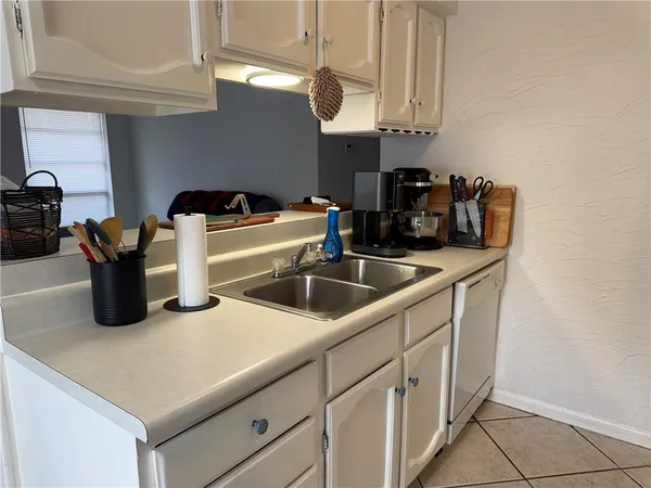 a kitchen with stainless steel appliances granite countertop a sink dishwasher a stove and a microwave oven