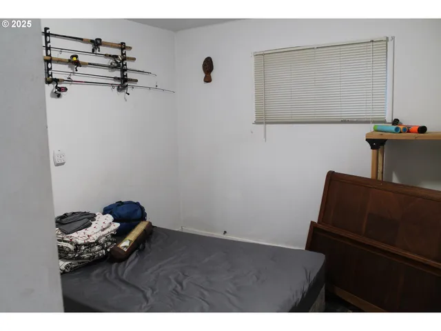 a bedroom with a bed and a mirror