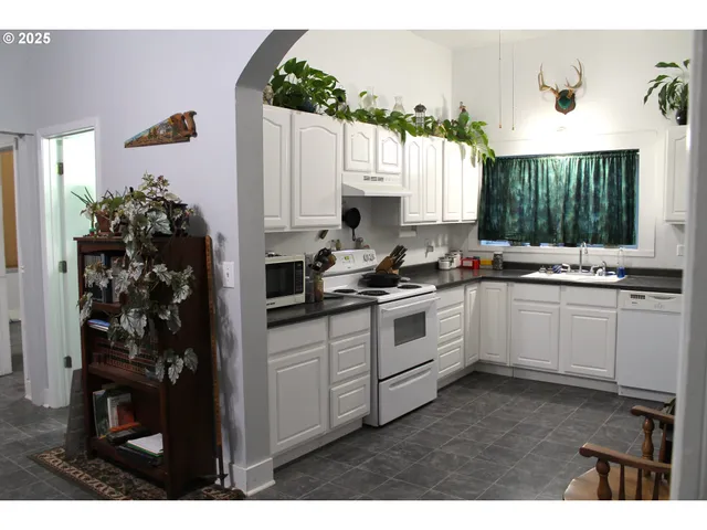 a kitchen with a refrigerator and a stove