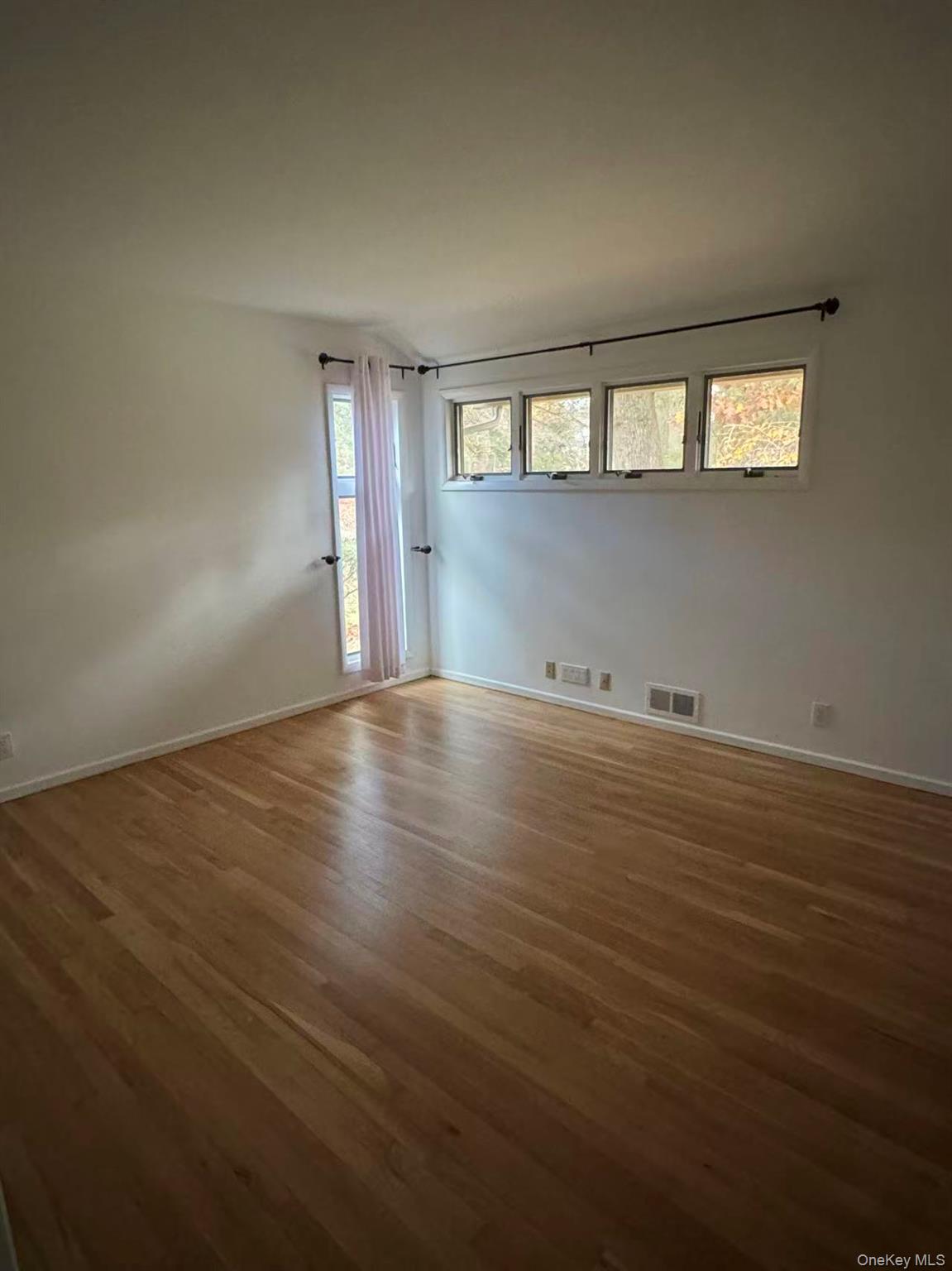 4 Norgate Road Glen Head, NY 11545 - Photo 11 of 25 an empty room with wooden floor and windows