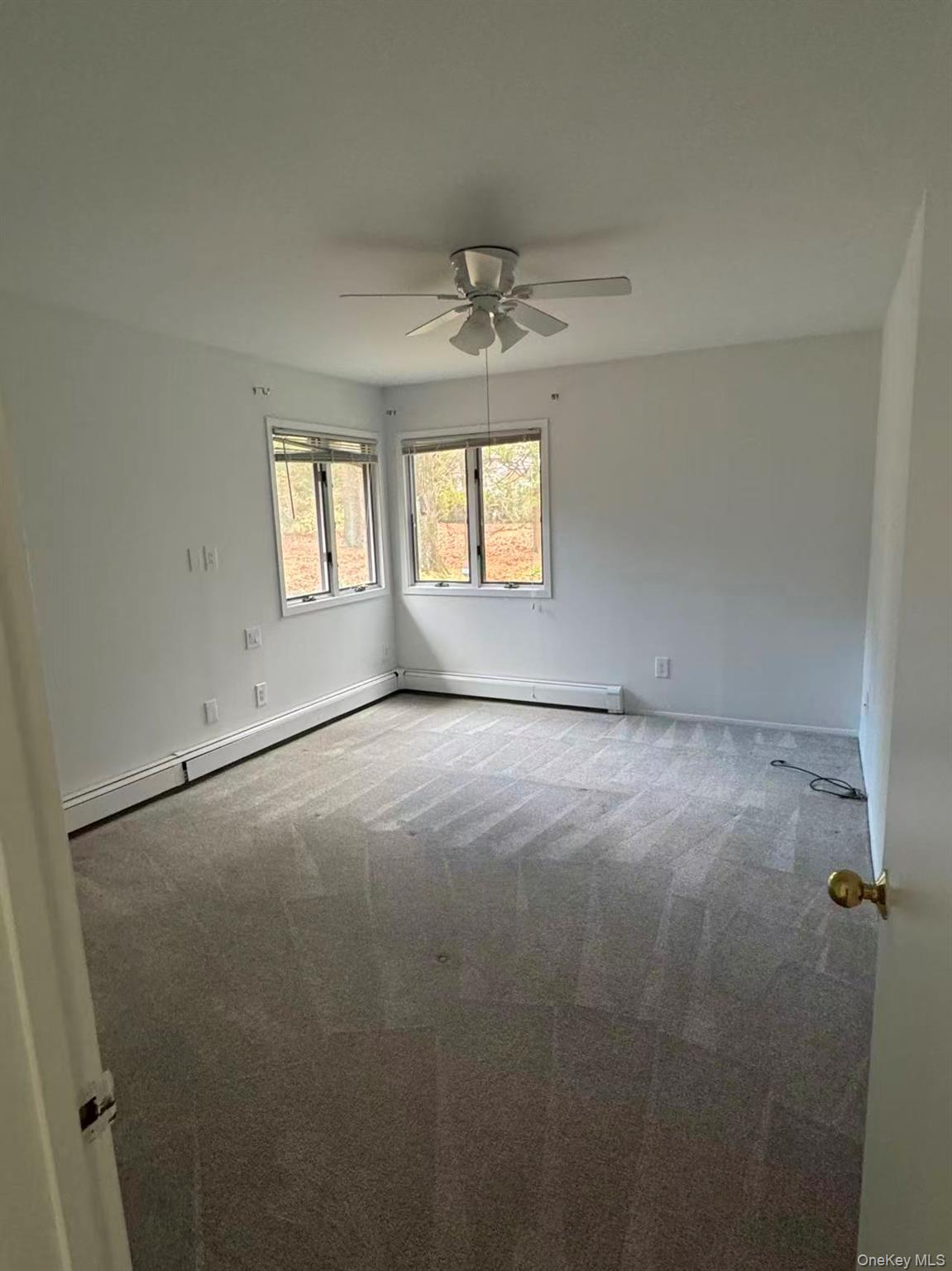 4 Norgate Road Glen Head, NY 11545 - Photo 17 of 25 an empty room with windows and ceiling fan