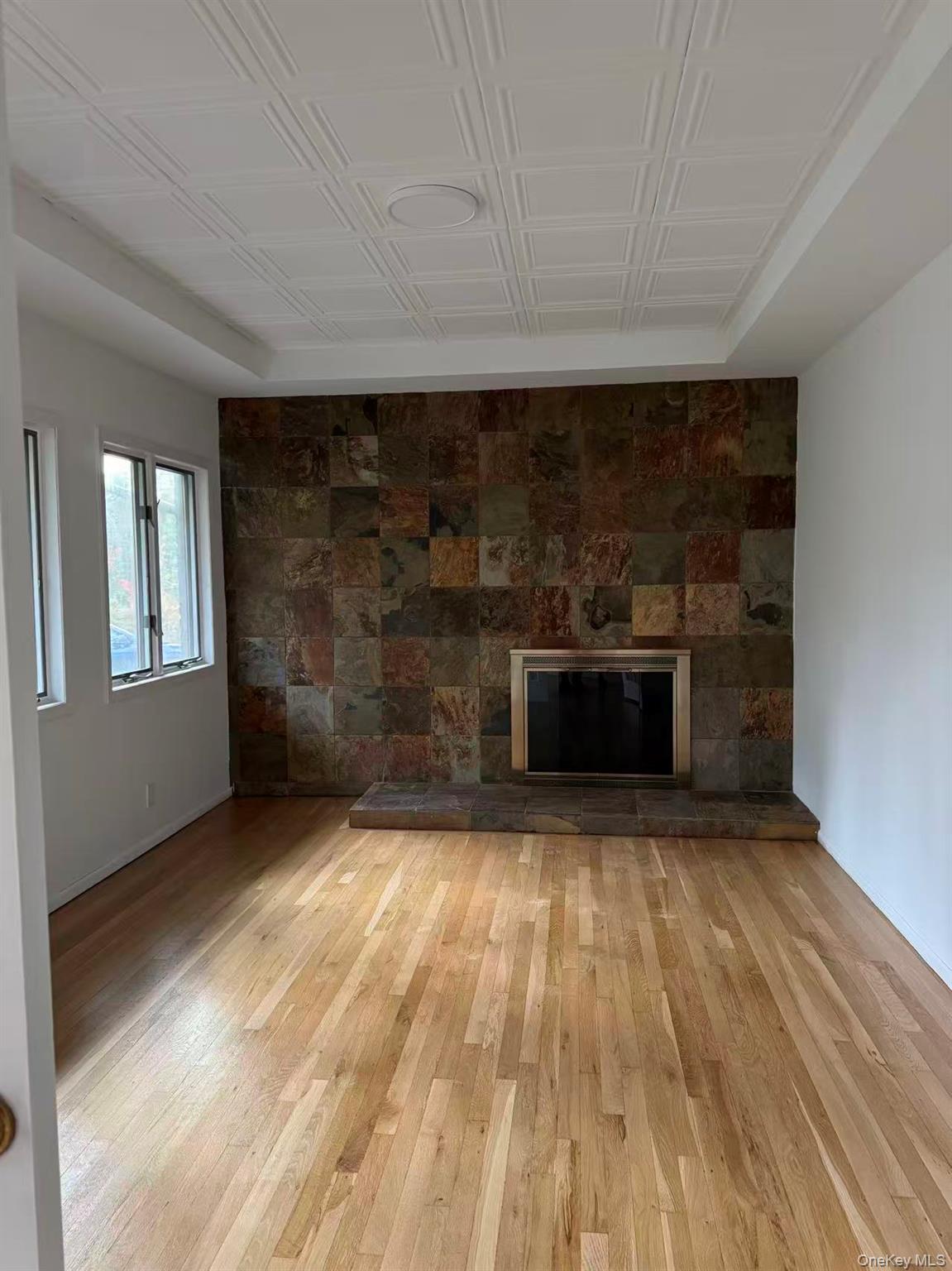 4 Norgate Road Glen Head, NY 11545 - Photo 25 of 25 a view of empty room with wooden floor and a fireplace