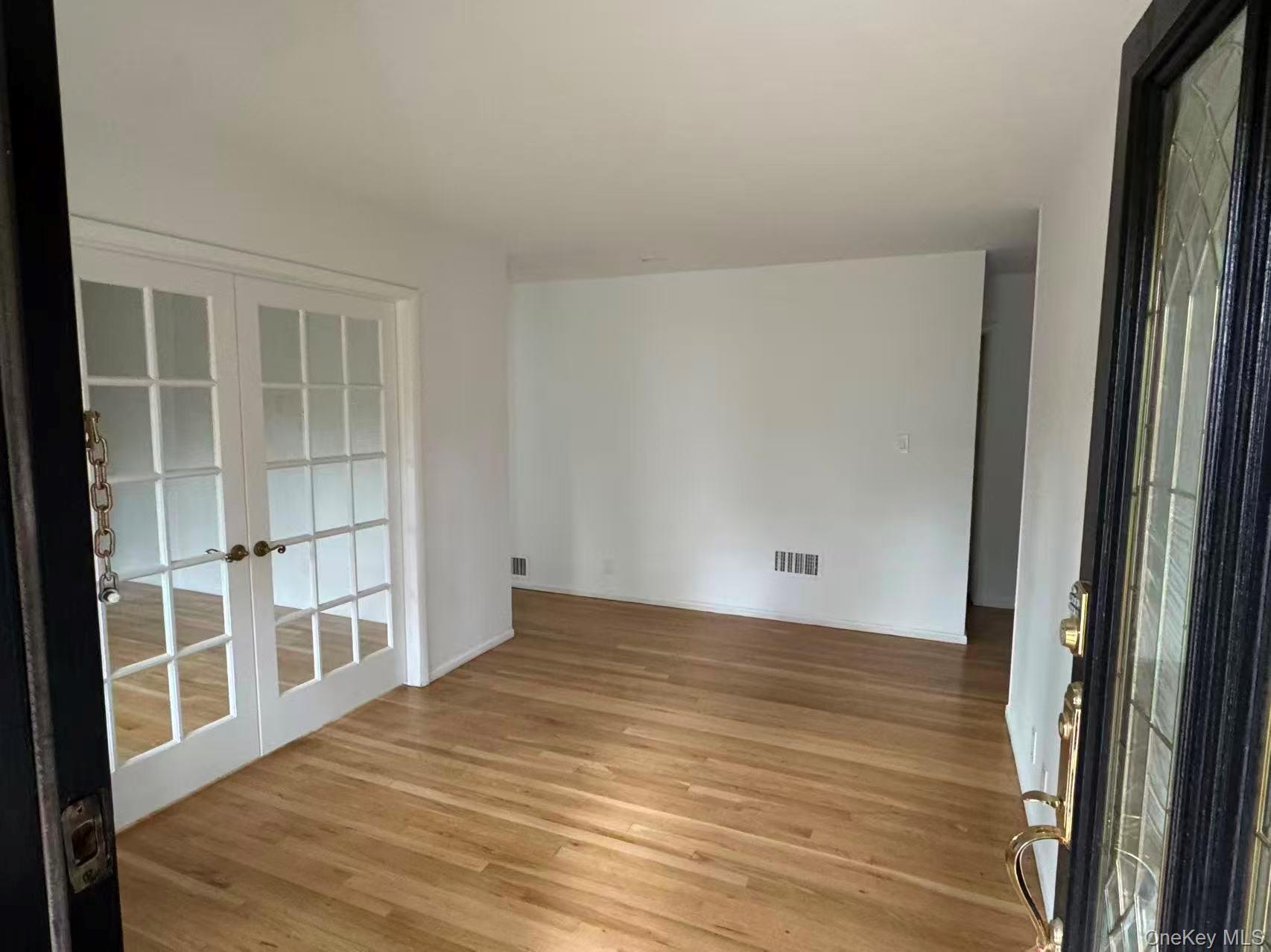 4 Norgate Road Glen Head, NY 11545 - Photo 9 of 25 a view of an empty room with wooden floor and a window