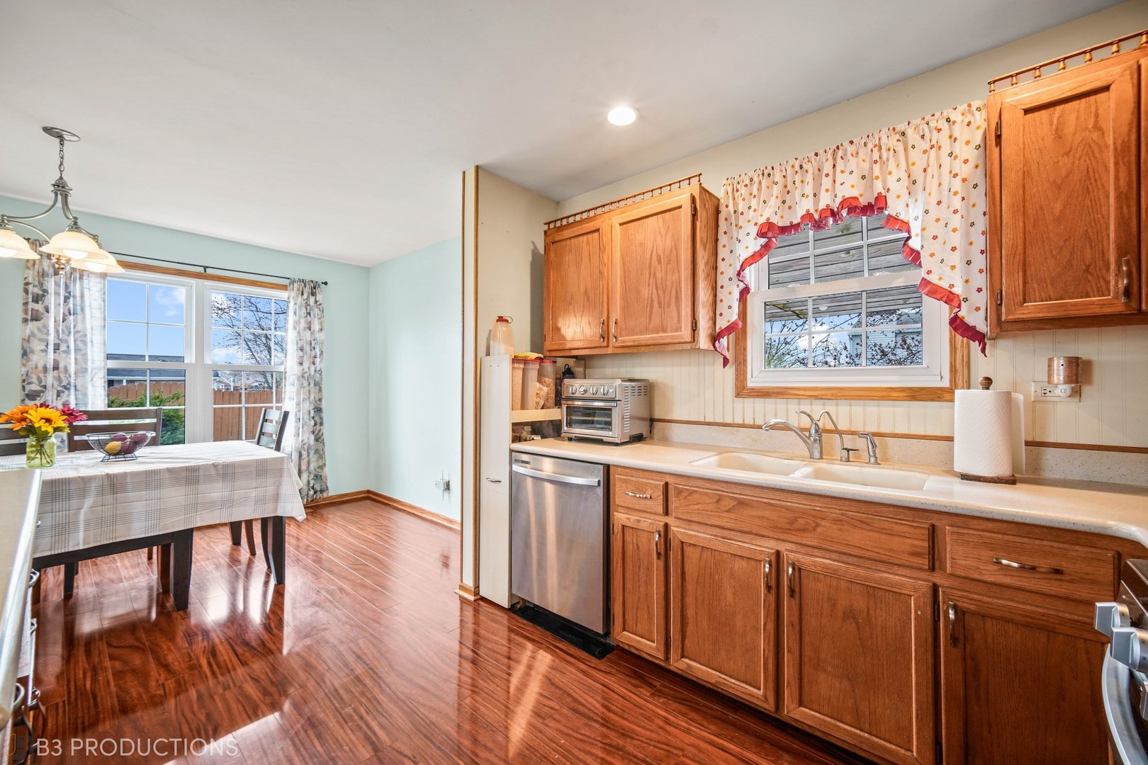 20656 South Acorn Ridge Drive Frankfort, IL 60423 - Photo 7 of 19 a kitchen with stainless steel appliances granite countertop a stove a sink dishwasher and a refrigerator with wooden floor
