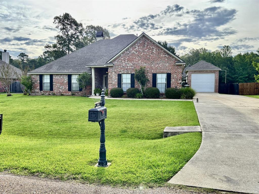 605 Jade Haughton, LA 71037 - Photo 34 of 34 Traditional brick exterior with an attached garage, covered entryway, and front yard landscaping