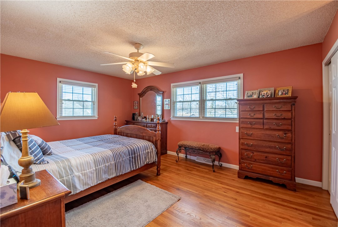 75 Ridgedale Drive Decatur, IL 62521 - Photo 11 of 26 a bedroom with a bed and wooden floor