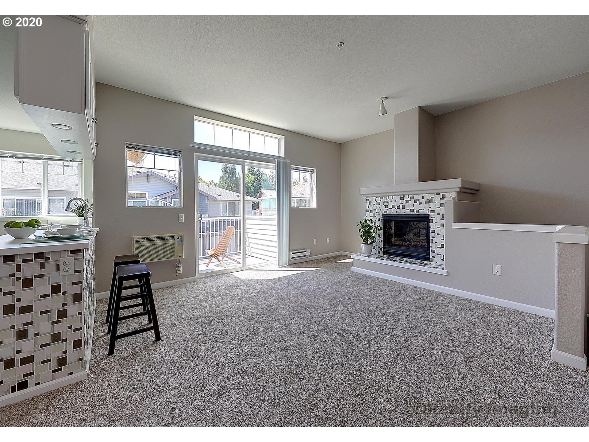 14805 Southwest Sandhill Loop, Unit 203 Beaverton, OR 97007 - Photo 3 of 20 a living room with furniture a fireplace and a flat screen tv