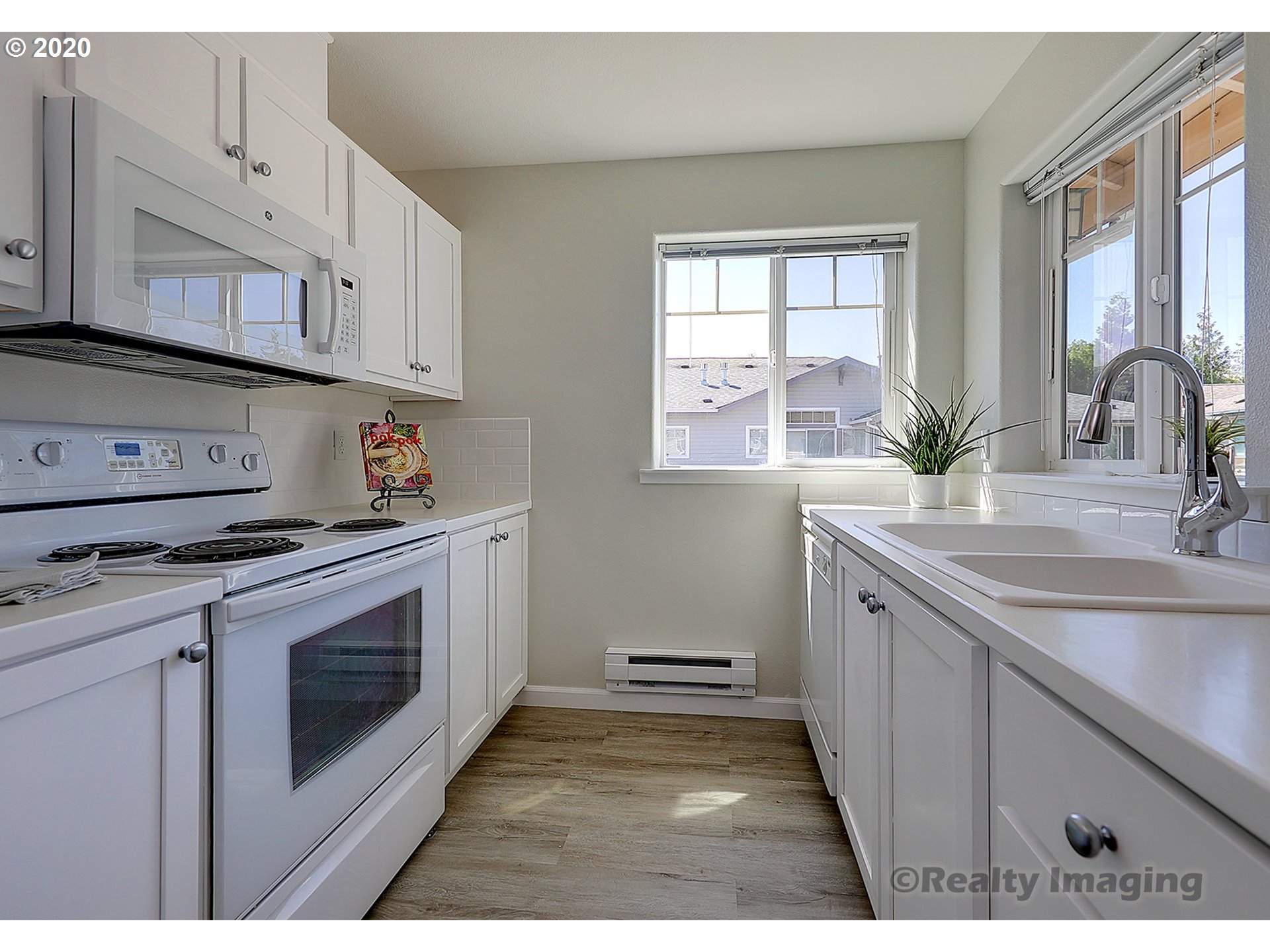 14805 Southwest Sandhill Loop, Unit 203 Beaverton, OR 97007 - Photo 5 of 20 a kitchen with stainless steel appliances granite countertop a sink stove and cabinets