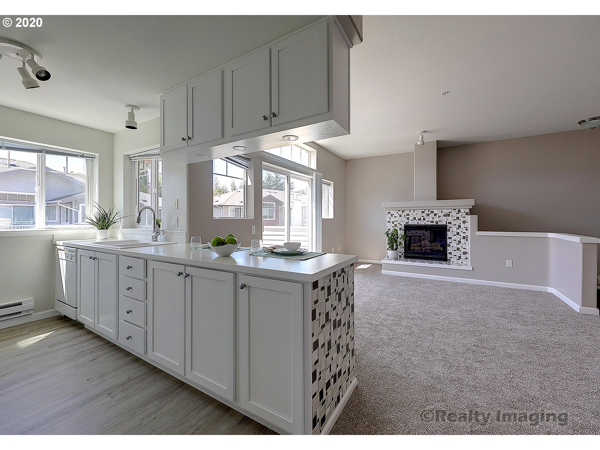 14805 Southwest Sandhill Loop, Unit 203 Beaverton, OR 97007 - Photo 6 of 20 a open kitchen with cabinets a stove and a wooden floors