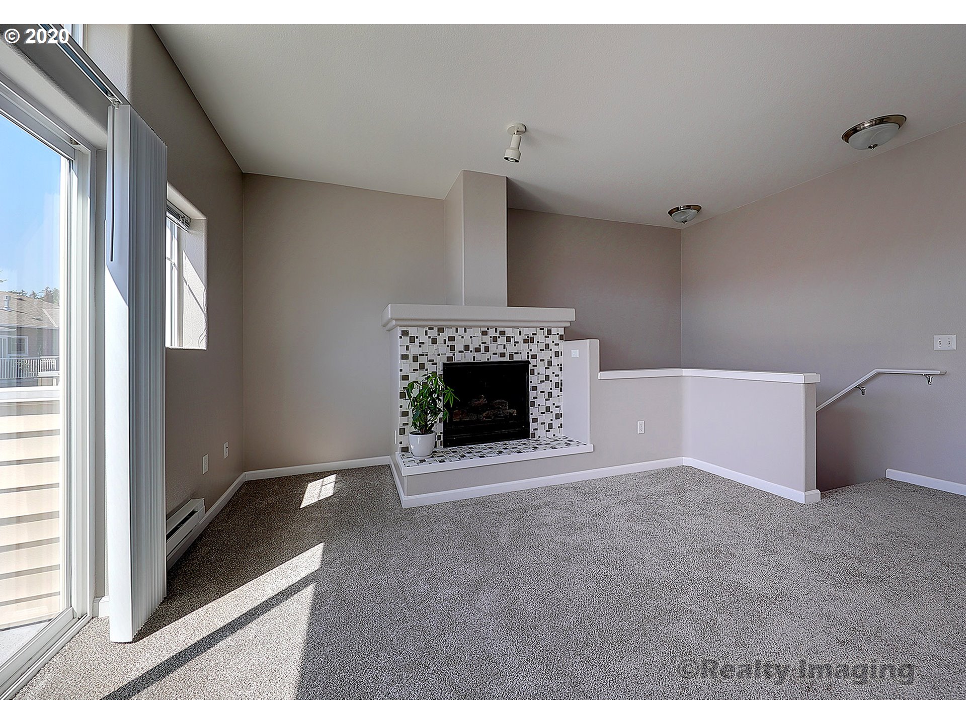 14805 Southwest Sandhill Loop, Unit 203 Beaverton, OR 97007 - Photo 7 of 20 a view of an empty room with a fireplace and a window