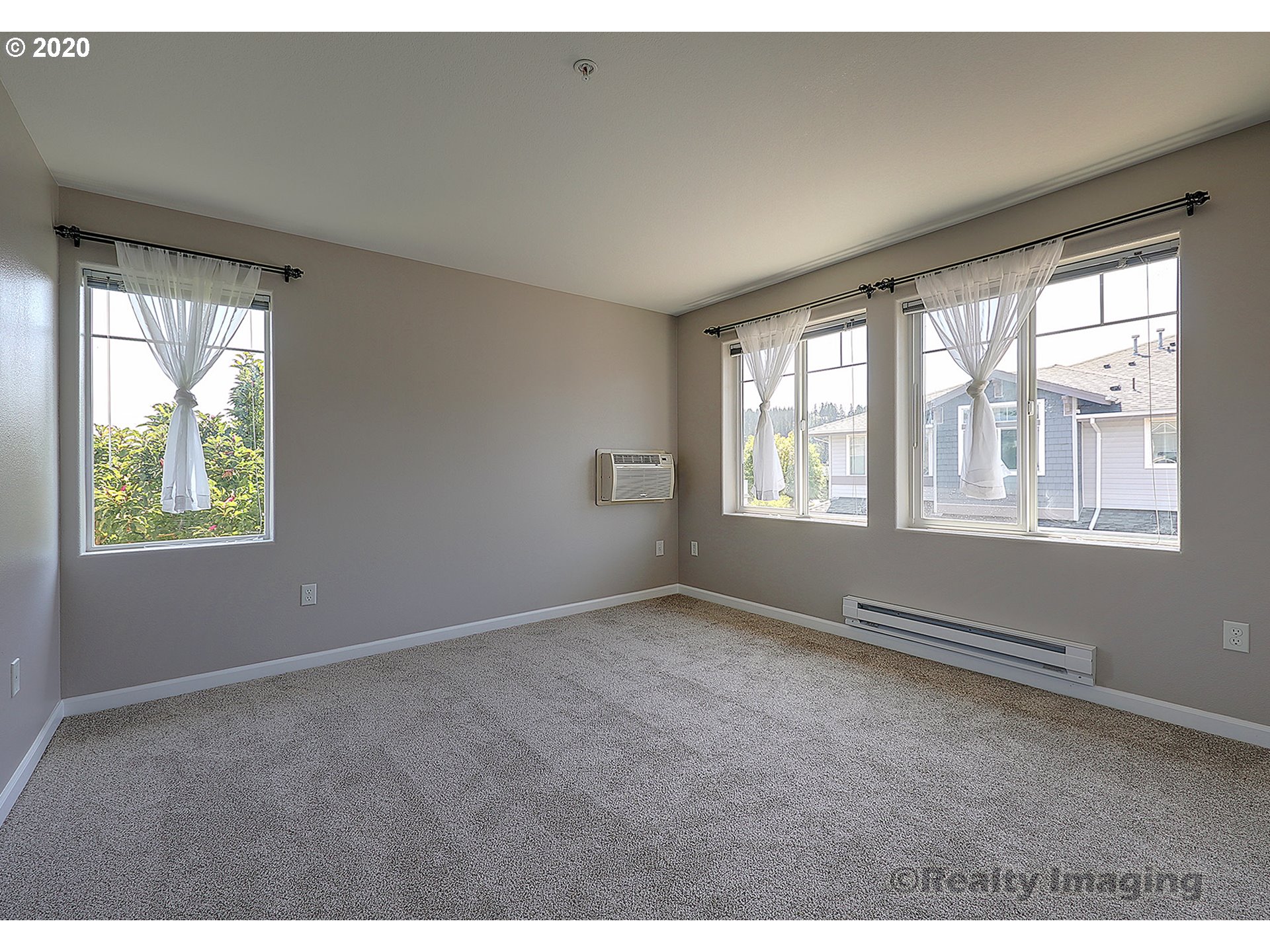 14805 Southwest Sandhill Loop, Unit 203 Beaverton, OR 97007 - Photo 8 of 20 a view of an empty room with a window