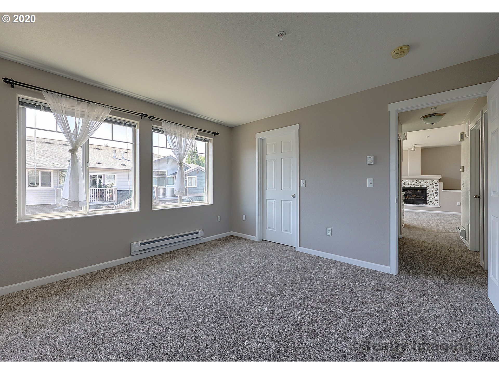 14805 Southwest Sandhill Loop, Unit 203 Beaverton, OR 97007 - Photo 9 of 20 a view of an empty room with a window