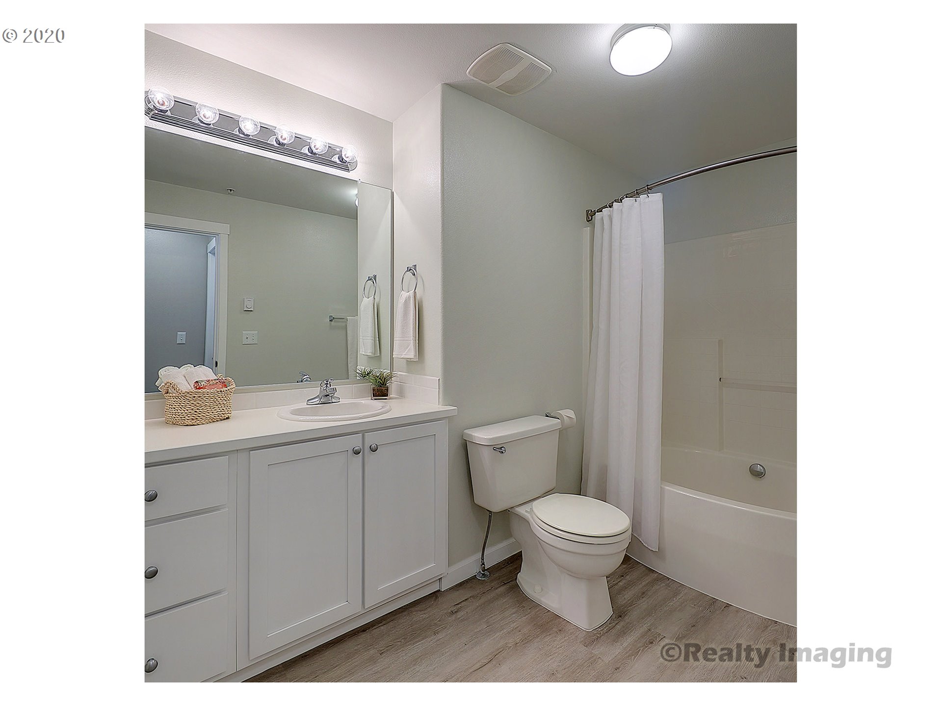 14805 Southwest Sandhill Loop, Unit 203 Beaverton, OR 97007 - Photo 10 of 20 a bathroom with a toilet a sink and a large mirror