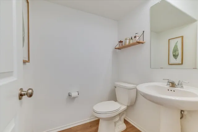 a bathroom with a sink toilet and mirror