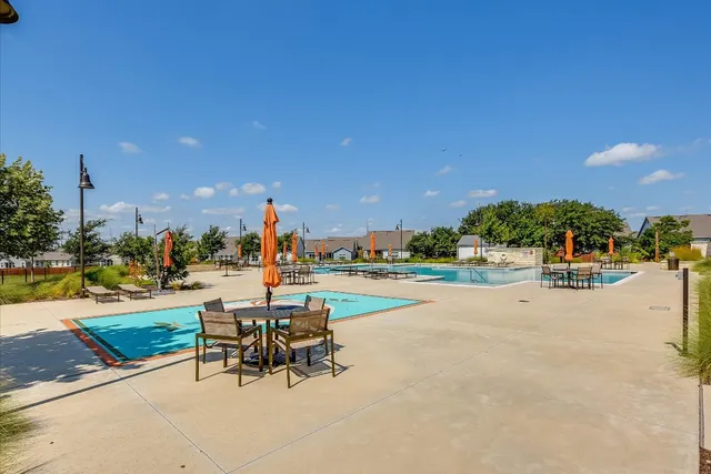 a view of a patio with a table and chairs