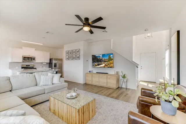 a living room with furniture and a wooden floor