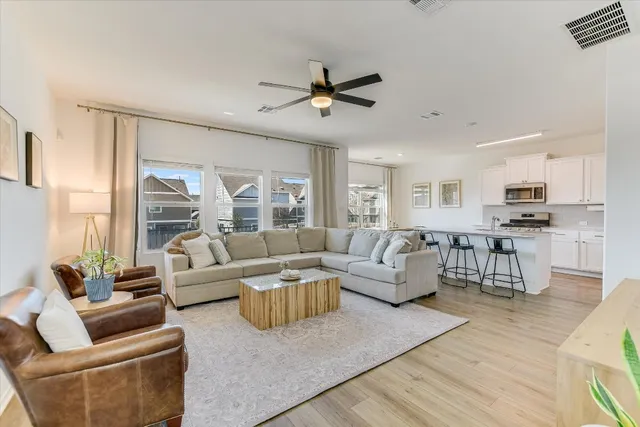a living room with furniture and a large window