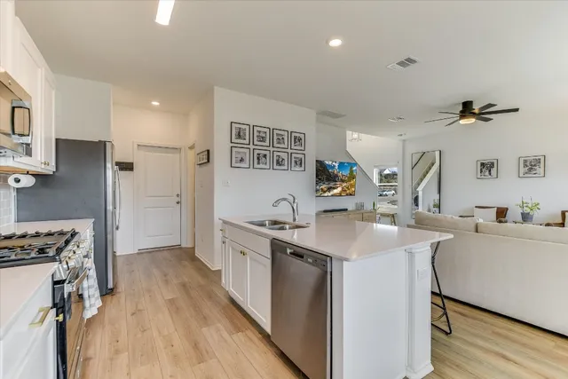 a kitchen with a sink stove and cabinets