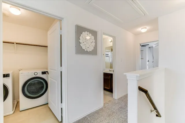 a view of a hallway with washer and dryer